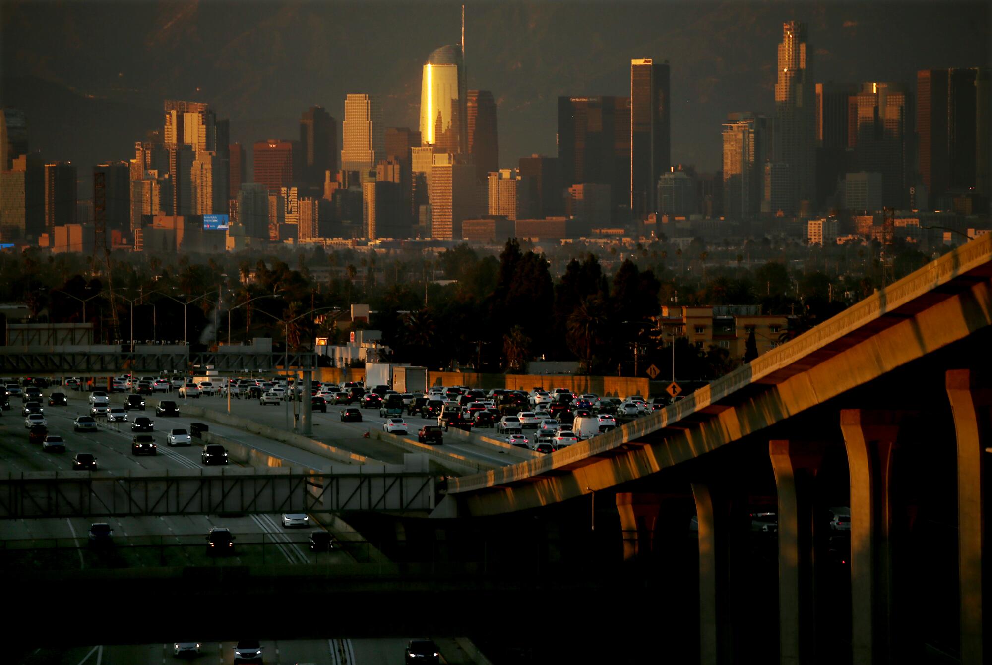 Un ciel smog, avec l'horizon du centre-ville de Los Angeles et une autoroute remplie de voitures
