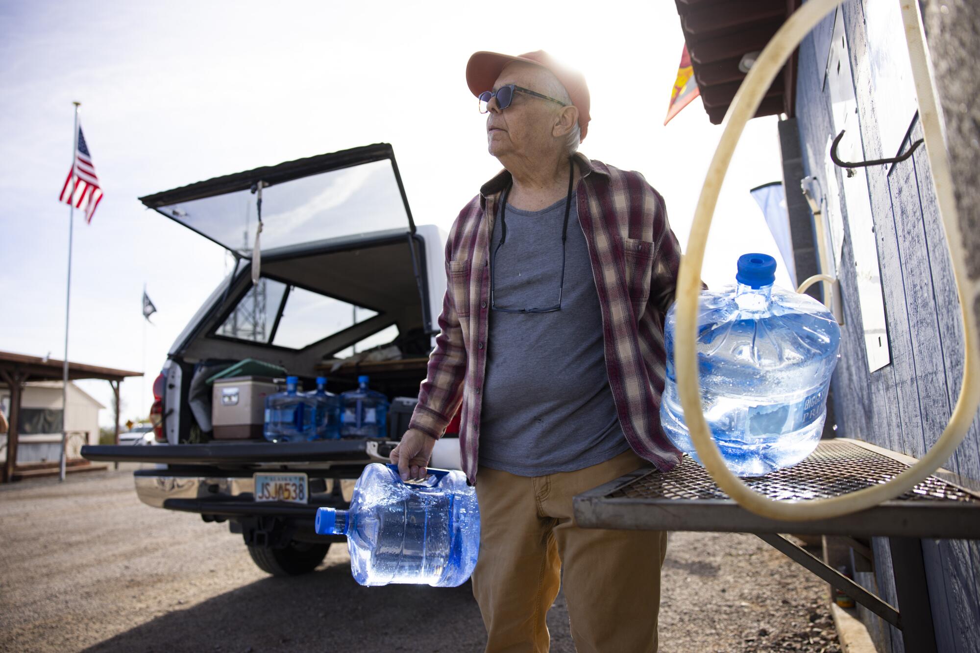 Grant Greatorex, qui vit juste à l'extérieur de Bouse, remplit des cruches dans une station de remplissage d'eau du Bouse RV Park.
