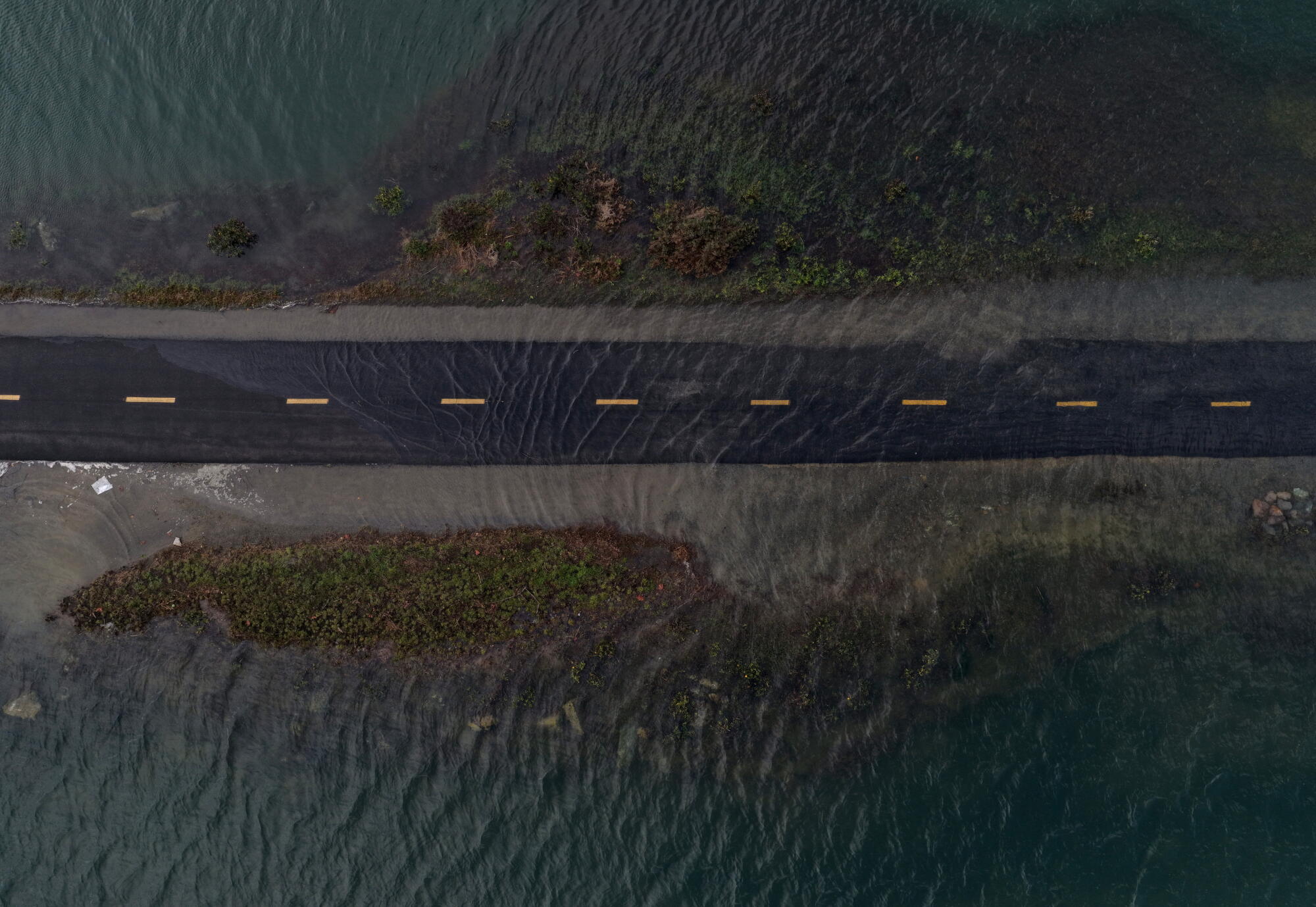 une vue aérienne, l'eau de mer inonde une piste cyclable